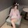 A woman wears a pink kimono-style lingerie set with bunny ears, featuring delicate patterns and ruffles, perfect for intimate...