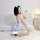 A woman poses with a smartphone, wearing a kino adorable japanese maid costume set featuring a lace bodice and skirt. the out...