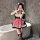 A woman poses in a bathroom wearing a cute kitty cat maid costume, featuring a black and white dress with red plaid skirt, fl...