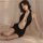 Woman wearing kouni sexy sleepwear deep v backless slip dress, a trendy bodycon nightgown with chain detail, posed on bed.