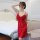 A woman poses elegantly in a red lace babydoll sleep dress, featuring sheer fabric and delicate lace details, perfect for rom...