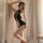 A woman poses elegantly in a black lace backless sexy lingerie set, featuring a daring cutout design and sheer fabric, perfec...