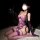 Woman wearing purple lace backless lingerie set with sheer mesh bra, steel underwire, and matching bodysuit.