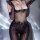 Sexy lace bodysuit with sheer mesh and glossy black stockings, featuring elegant floral patterns and sparkling embellishments...