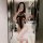 Woman wearing black lace bodysuit with open-crotch cheongsam design, posing in bathroom mirror selfie.