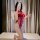 Woman wearing red lace bodysuit with open-crotch cheongsam style, tight-fit flirty sleepwear for erotic occasions.