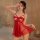 Woman wearing red lace butterfly bralette set with sheer skirt, posing in romantic bedroom setting for date night allure.