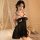Woman wearing black lace butterfly bralette set with sheer dress, romantic bedroom sleepwear for date night.