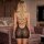 Blonde woman wearing a black lace-up crystal-embellished backless bodysuit, featuring sheer knit design, displayed in an eleg...