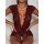 Woman wearing burgundy lace deep v-back seductive sleepwear with sheer cutouts and floral trim, hands on hips.