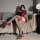 Woman wearing red lace garter stockings set with sheer over-the-knee design and adjustable silk-like garter belt, paired with...