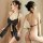 Woman modeling black lace halter neck bodysuit with bow detail and backless thong set, premium erotic lingerie for women.
