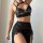 Sexy black lace halter neck lingerie set with high slit and bondage style design for women.