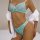 Woman wearing turquoise sheer mesh lingerie set with heart embroidery, paired with white shirt draped off shoulders.