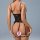 Woman wearing black lace lingerie set with open back and crotch, featuring delicate straps and seductive design.