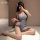 A woman poses seductively in a lace hollow-out high-waist slit mini dress made of sheer mesh fabric, perfect for boudoir wear...