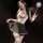 Woman modeling lace jk style sensual lingerie set with bow detail - busty sheer peek-a-boo maid outfit, holding feather wand.