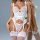 Woman wearing white lace mesh bodysuit with corset-style shapewear and attached stocking belt, featuring floral embroidery an...