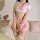 A woman models a lace mesh jk costume set featuring a sailor-style top with a pink bow, sheer tights, and a mini skirt. the o...