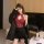 Woman wearing red lace mesh sheer bodysuit with cut-outs and ties, styled as streetwear-inspired sexy lingerie set.