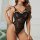 Woman modeling black lace pure-temptation bodysuit, backless sexy lingerie with floral lace and bow straps.