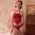Woman wearing red lace bodysuit set with open-crotch design, elegant sleepwear for women.