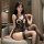 A woman poses in a lace bodysuit with an open crotch design, featuring black stockings and intricate lace details, creating a...