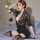Woman wearing black lace deep v-neck bodycon mini dress with sheer sleeves and thigh-high stockings, styled as sexy sleepwear...