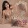 Woman modeling a sheer mesh bodysuit with cut-outs and rhinestone details, styled as a seductive lingerie set for nightclub w...