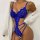 Woman wearing royal blue luxury lace sheer bodysuit with intricate floral patterns, paired with a white cardigan.