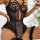 Woman wearing black lace lingerie set with sheer panels and garter straps, luxury european-style erotic underwear.