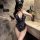Woman wearing black lace sheer open-crotch bodysuit with cat ears, holding a whip in bathroom mirror selfie.