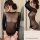 Woman wearing black lace sheer lingerie set, featuring mesh sleepwear design for intimate moments and date nights.