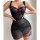 Woman wearing black lace sheer sleepwear set with pink floral embroidery, featuring matching bra and mesh nightgown.