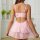 Woman wearing pink lace lingerie set with adjustable straps and sheer mesh sleep dress, back view.