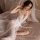 A woman poses elegantly in a sheer lace robe with a high slit, exuding sensuality and grace. the delicate design highlights f...