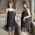 Woman wearing black lace sleep dress with sheer backless design, romantic lingerie set for bedroom lounge.