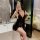 Woman in luxury lace sleepwear taking mirror selfie; sheer satin slip dress with push-up support and elegant embellishment.