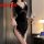 Woman in black lace temptation cross-strap nightgown holding wine glass, showcasing sexy backless silk-like boudoir dress wit...