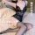 Woman wearing black lace temptation sheer sexy sleepwear set with open-crotch bodysuit, posing on bed in stockings.