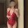 Sexy red lace bodysuit with open crotch design, featuring adjustable straps and sheer mesh fabric for a glamorous look.