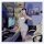 Woman in lace trim lingerie sleep set with sheer slip dress, posing in gaming room setup.