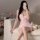 A woman poses in a pink lace trim sleep dress, featuring cherry patterns and a sweet design. the sleeveless dress includes bu...