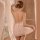 A woman models a lace-trimmed sheer ruffled cami dress, featuring a halter neck design and sensual mesh sleepwear set.