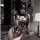 Woman wearing a leopard print lingerie set featuring a sexy, open-crotch bodysuit with sheer cutouts and bondage-style straps...
