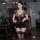 A woman poses in a leopard print secret lingerie set, featuring a lace-trimmed thigh-high stocking and a plunging neckline, e...