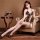 Woman wearing leopard print sexy bodysuit with halter neck and open back, sitting elegantly on a leather chair beside a wine ...