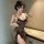 Woman wearing a leopard print sexy lace sleep dress with built-in pads, holding a wine glass.