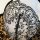 Close-up of sheer mesh bra with black floral embroidery over leopard print lining.