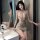 Woman in shimmering gold liaru factory sexy lingerie dress, tight bodycon club outfit with cutouts, posing by sink.